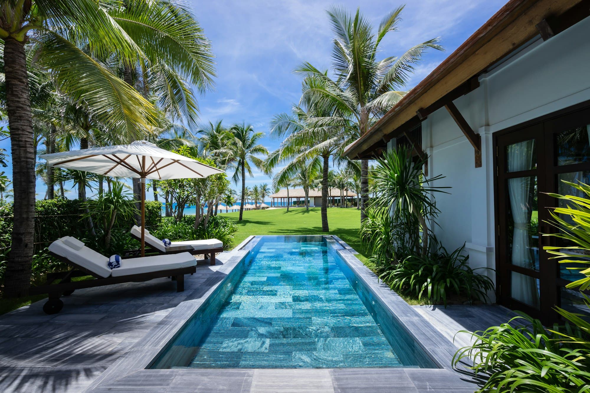 Private pool villa among palm trees