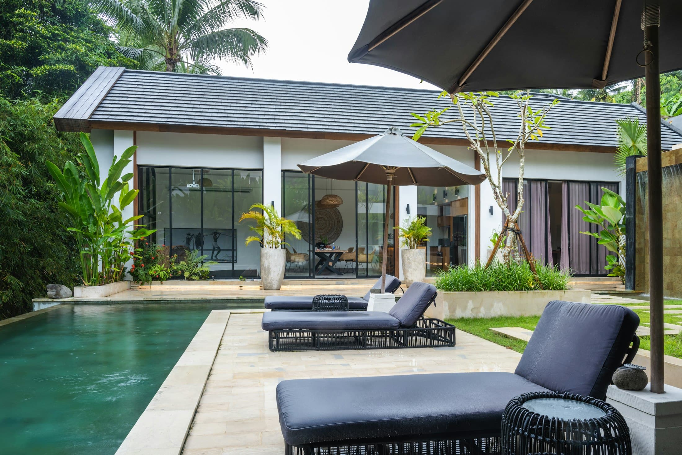 Modern villa pool with sun loungers